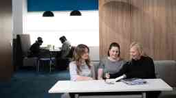 People doing work together on a desk