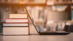 Books and a laptop in a library