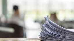 A stack of paper on a desk