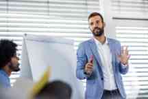 Young manager talking on a business presentation in a board room.