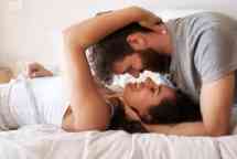 一对深情的年轻夫妇在家里的卧室里分享浪漫的时刻