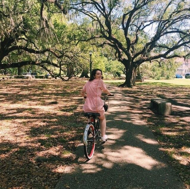骑自行车穿过公园的女人