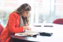 Female students wearing a red coat studying