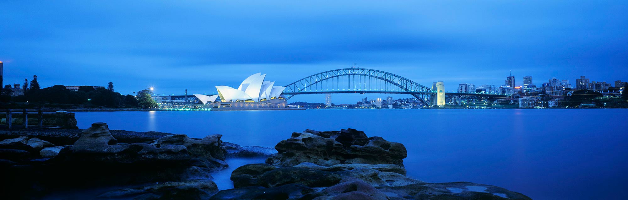 悉尼海港大桥在昏暗的光线下左边的歌剧院。